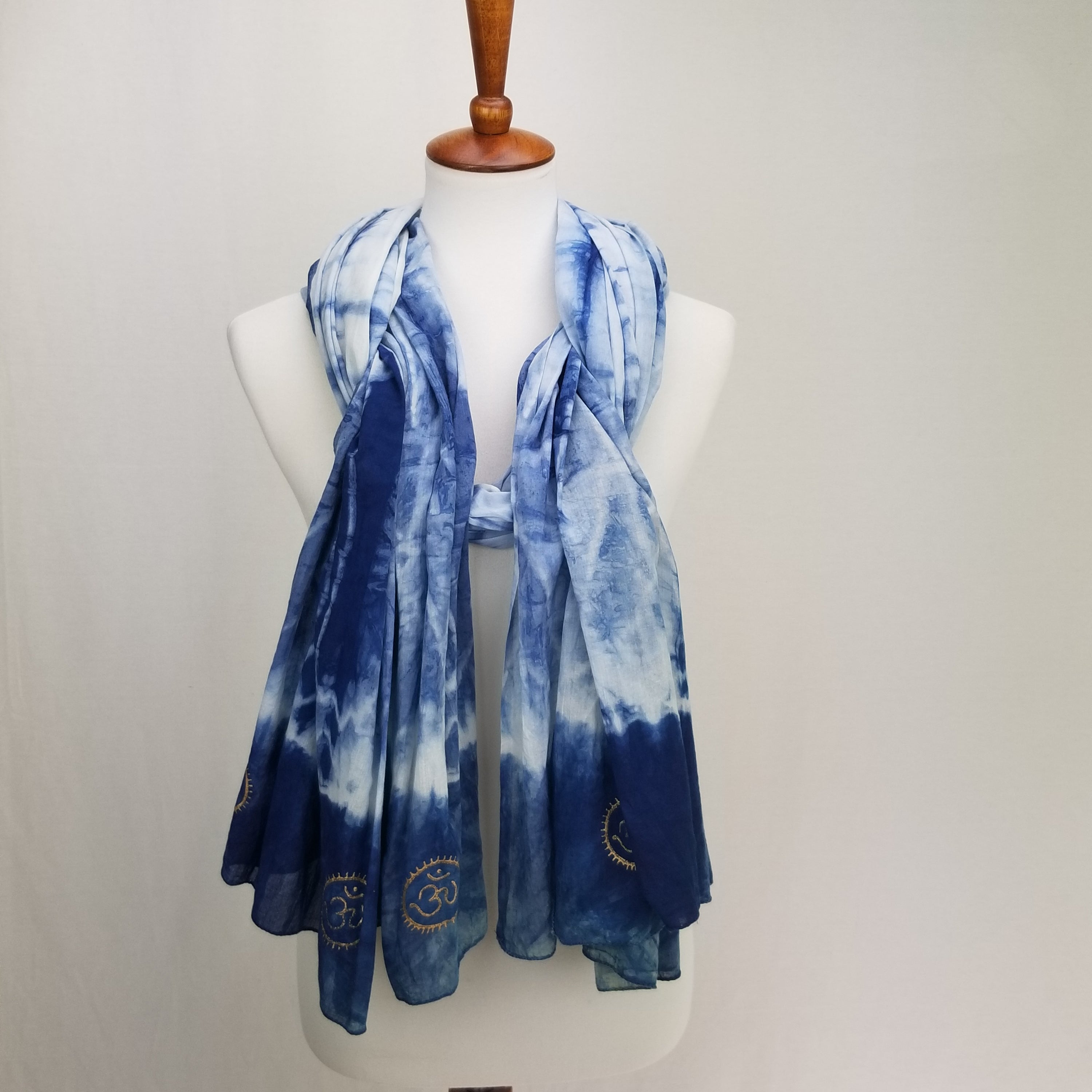 Eternity Indigo Cotton Scarf featuring hand-dyed indigo fabric and golden OM symbols at both ends.