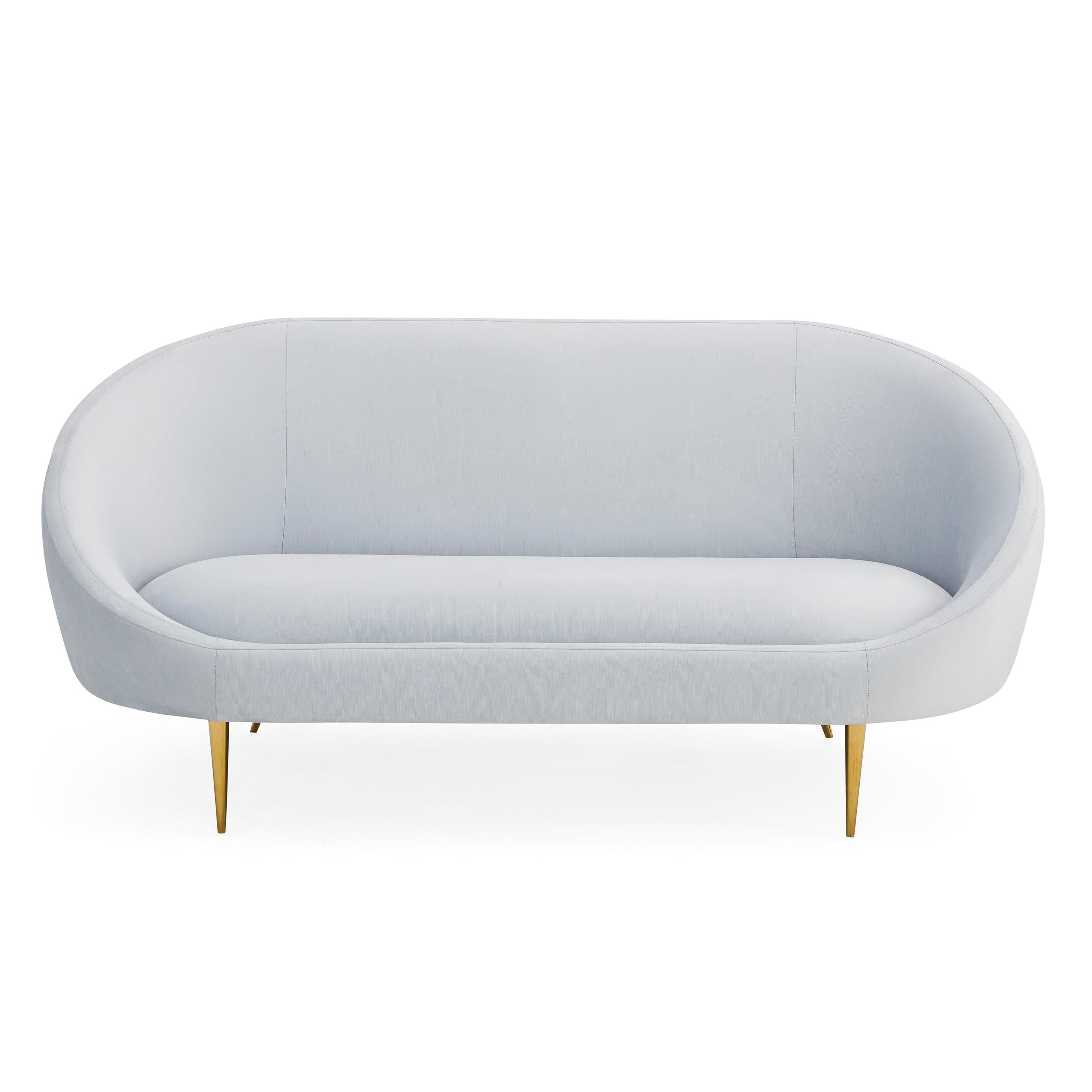 Ether Apartment Sofa featuring icy velvet upholstery and brass stiletto legs, designed for comfort and elegance.