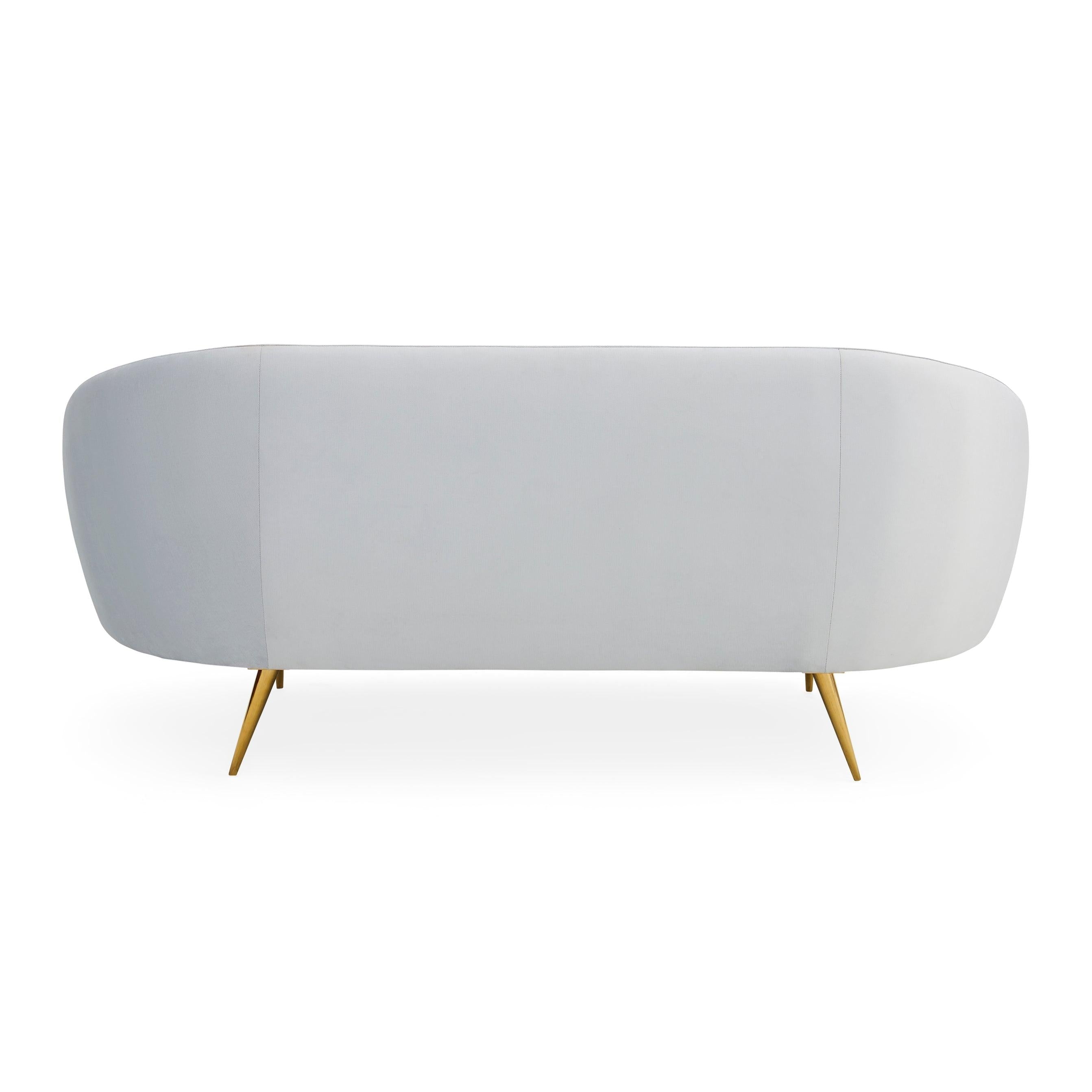 Ether Apartment Sofa featuring icy velvet upholstery and brass stiletto legs, designed for comfort and elegance.