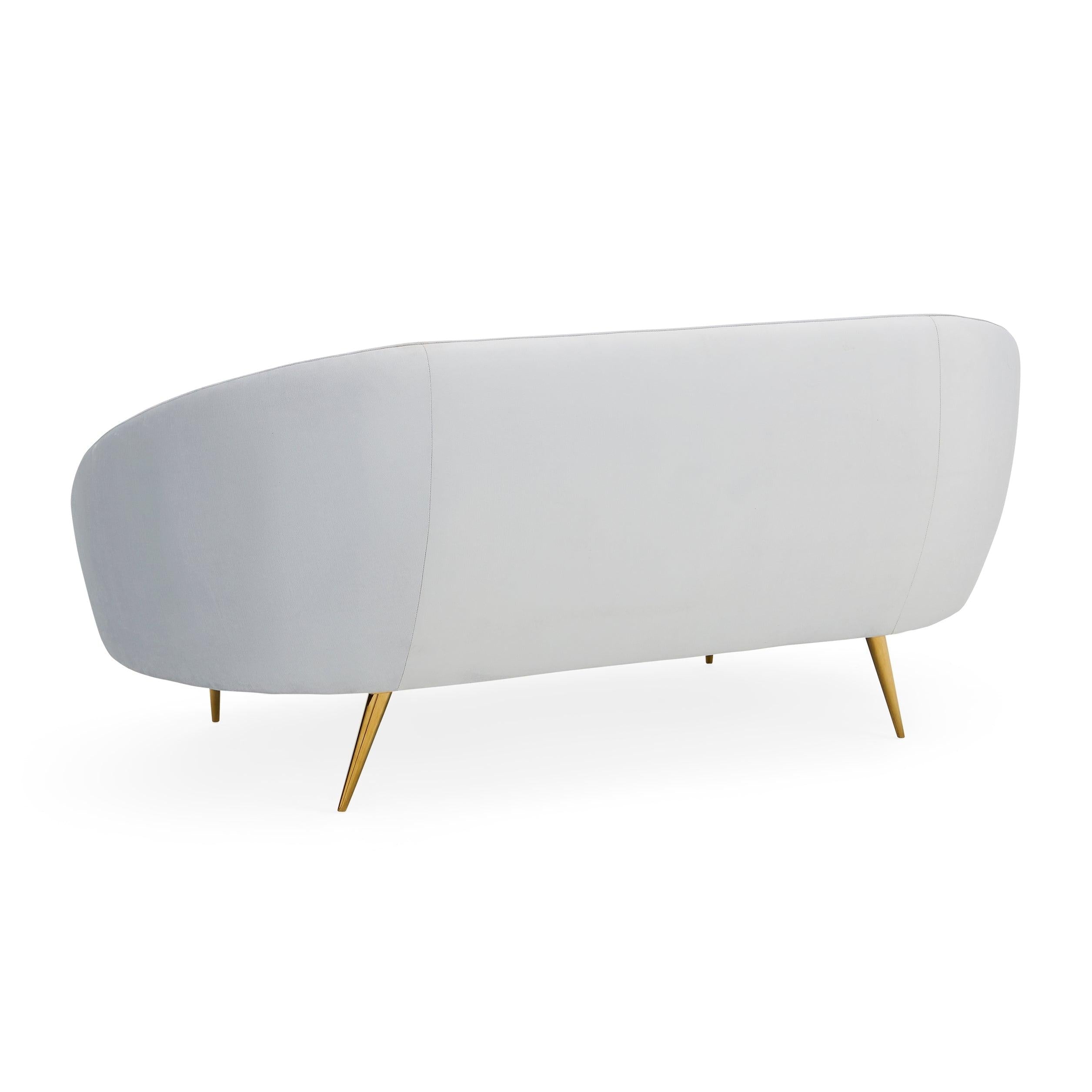 Ether Apartment Sofa featuring icy velvet upholstery and brass stiletto legs, designed for comfort and elegance.