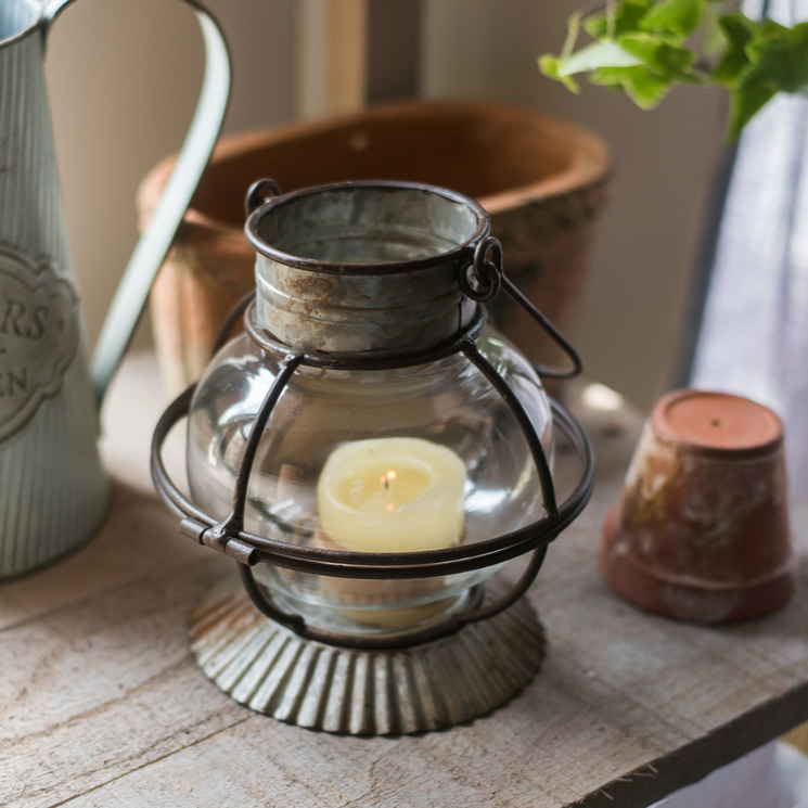 European Restoration Candle Holder in gray and rust, made of glass and metal, showcasing its elegant design and dimensions.