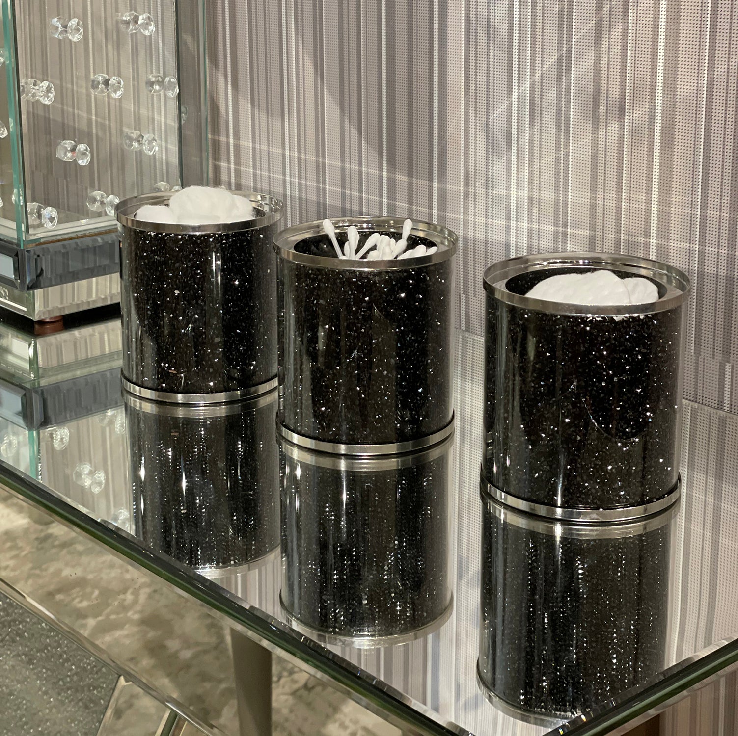 Exquisite three glass canister set featuring black crushed diamond glass with decorative chrome base and glass lids.