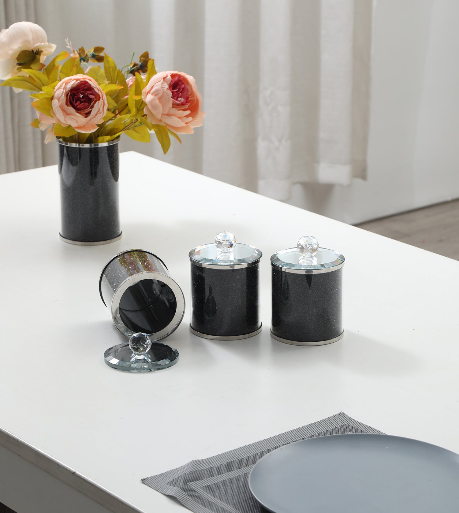 Exquisite three glass canister set featuring black crushed diamond glass with decorative chrome base and glass lids.