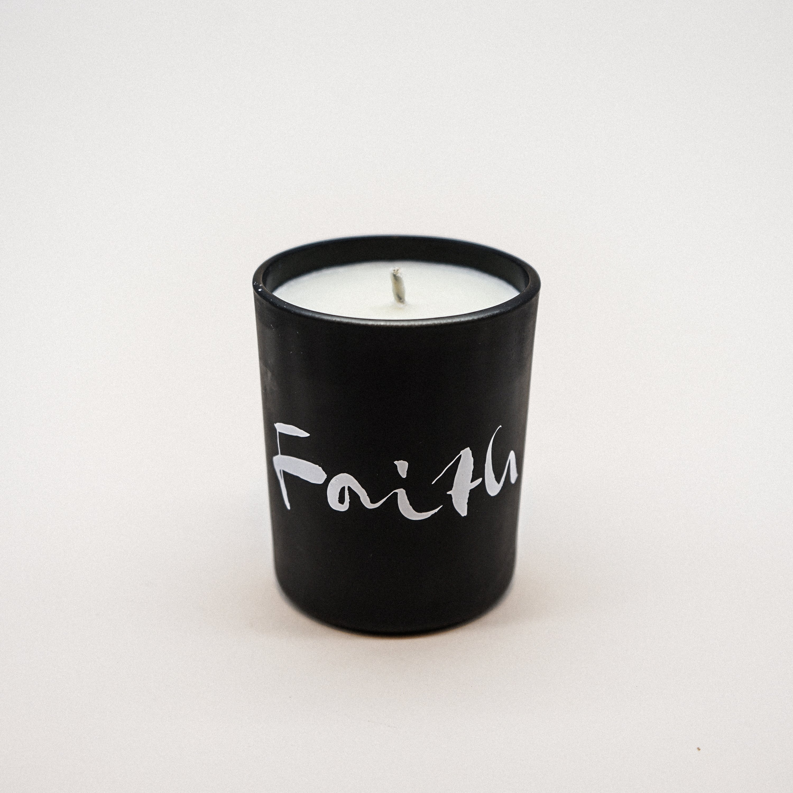 Faith Natural Wax Candle in black glass with faith brush painting design, showcasing a luxurious blend of essential oils.