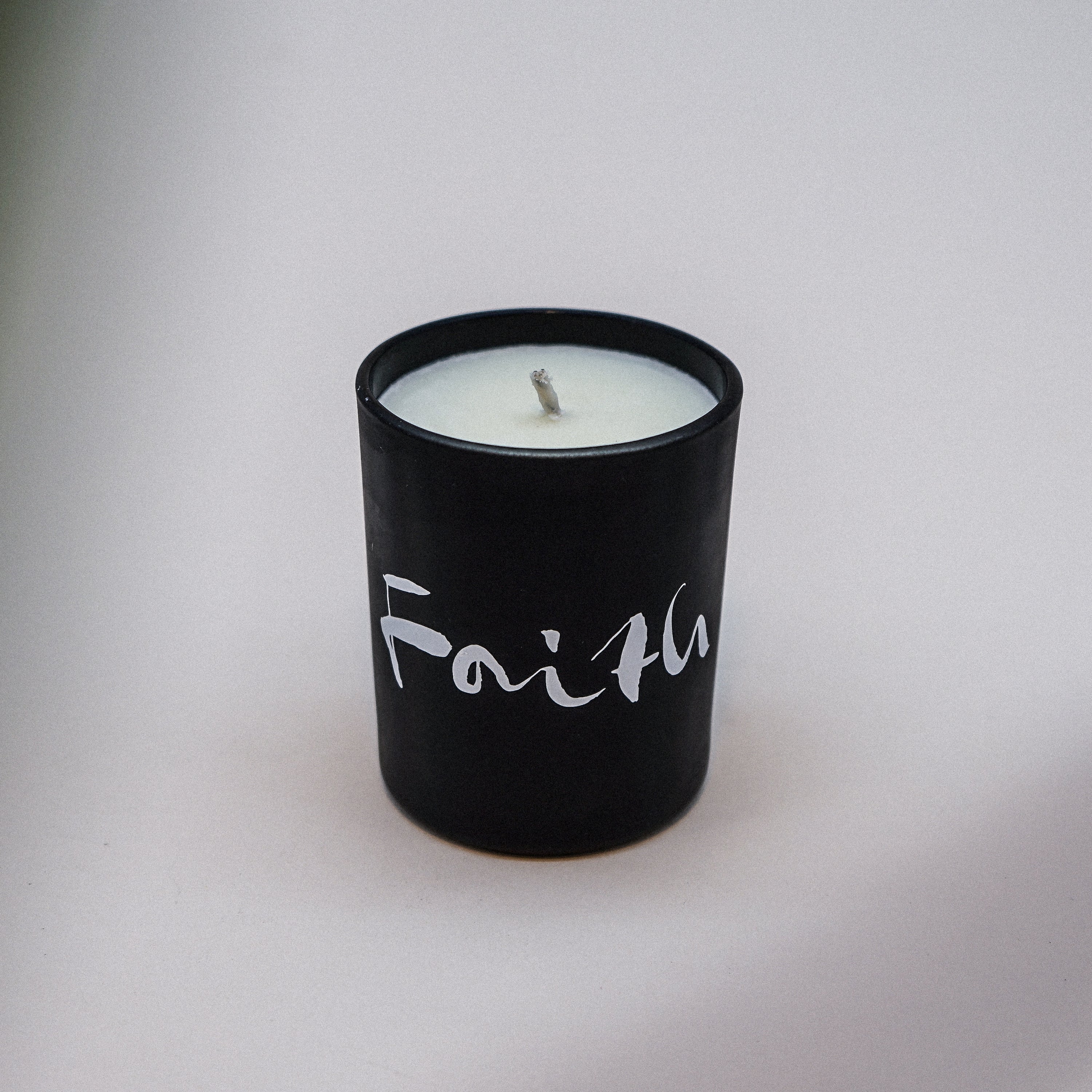 Faith Natural Wax Candle in black glass with faith brush painting design, showcasing a luxurious blend of essential oils.