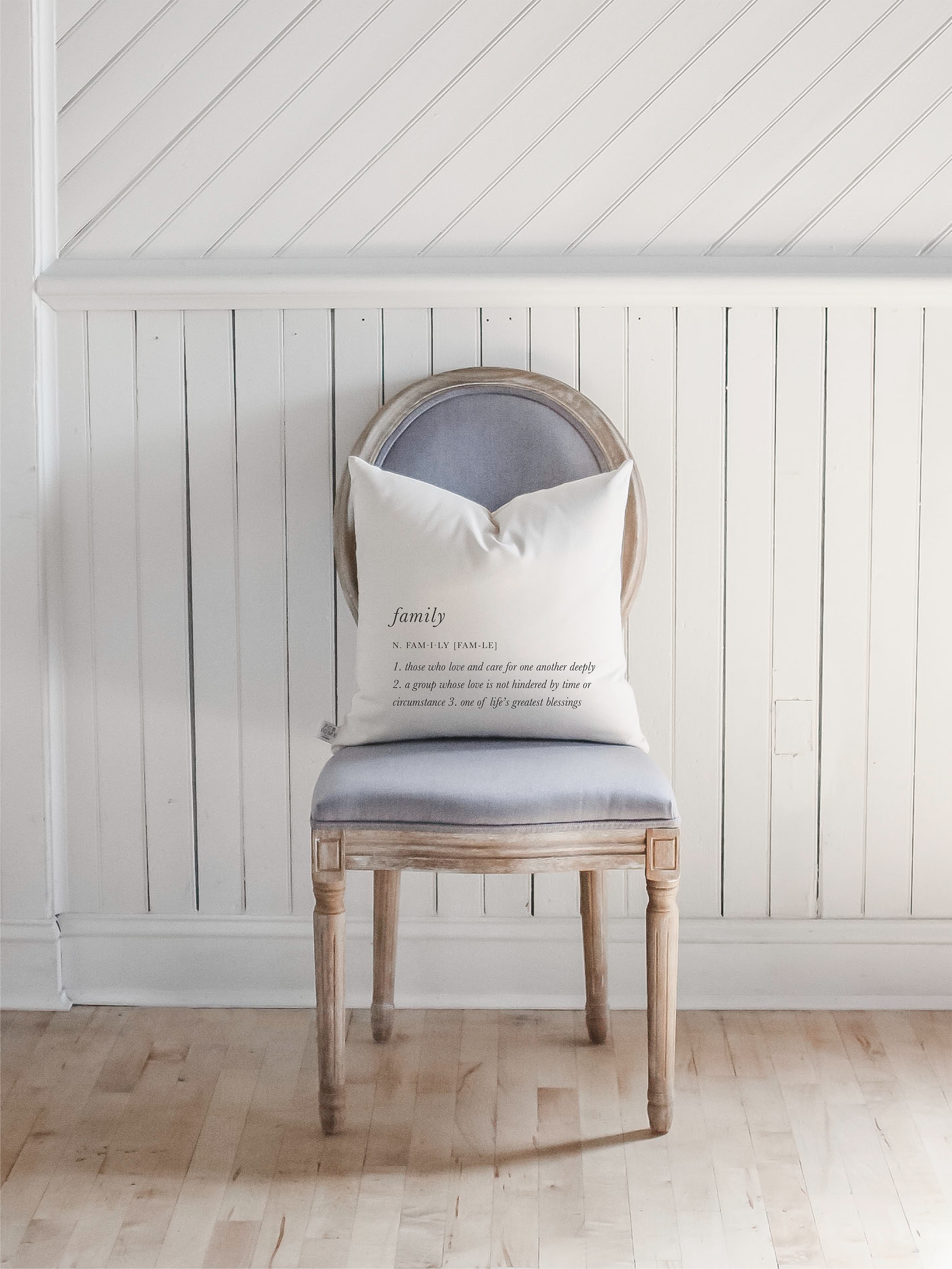 A cozy Family Definition Pillow featuring unique calligraphy designs on soft, natural cotton fabric, perfect for home decor.