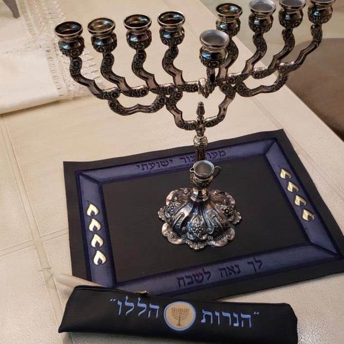 Elegant leather Menorah mat with embroidered Hanukkah phrases and matching shamash pouch, available in three colors.