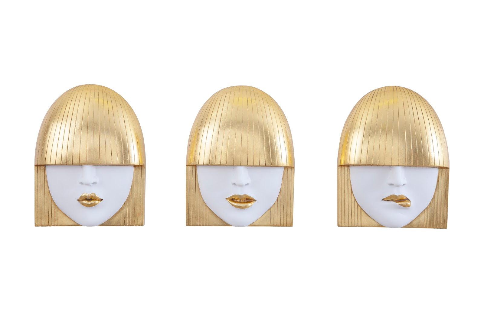 Fashion Faces Small Gold Wall Art Set featuring three expressive sculptures in gold and white finishes, showcasing smiling, pouting, and kissing faces.