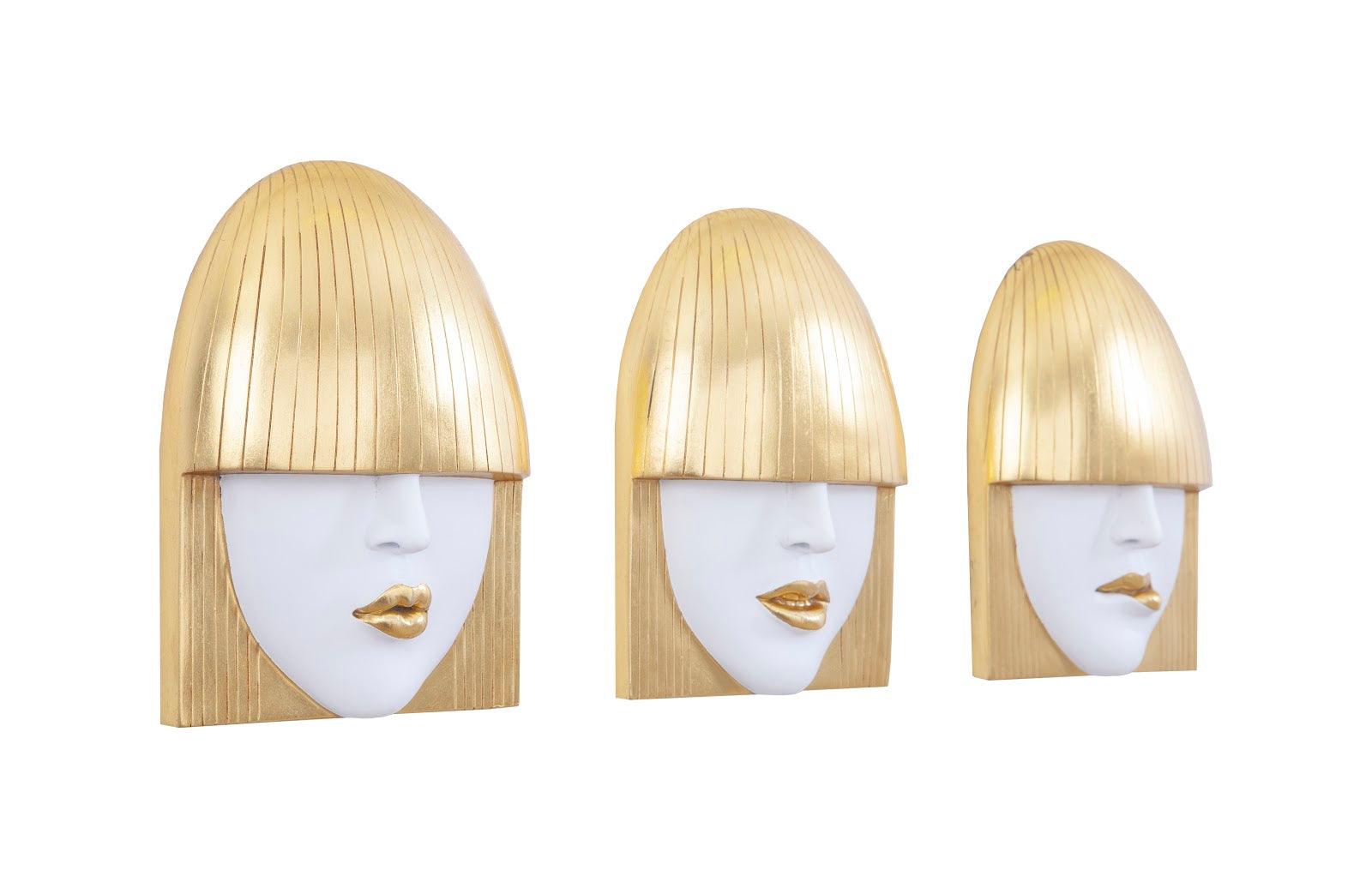 Fashion Faces Small Gold Wall Art Set featuring three expressive sculptures in gold and white finishes, showcasing smiling, pouting, and kissing faces.