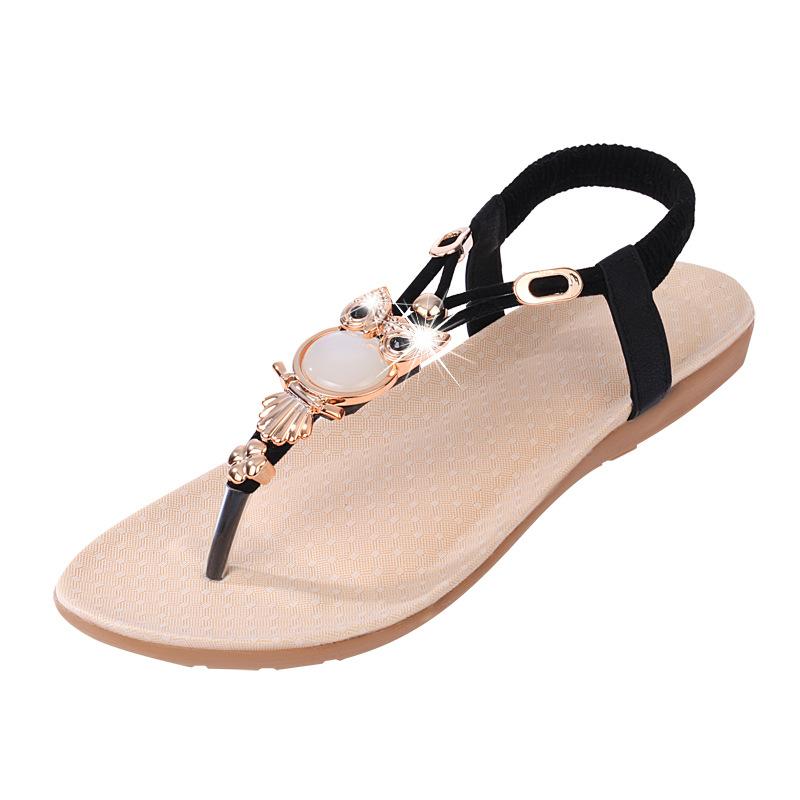 Fashionable Bohemian women's sandals with owl bead embellishments, featuring a flat heel and open side vamp design.