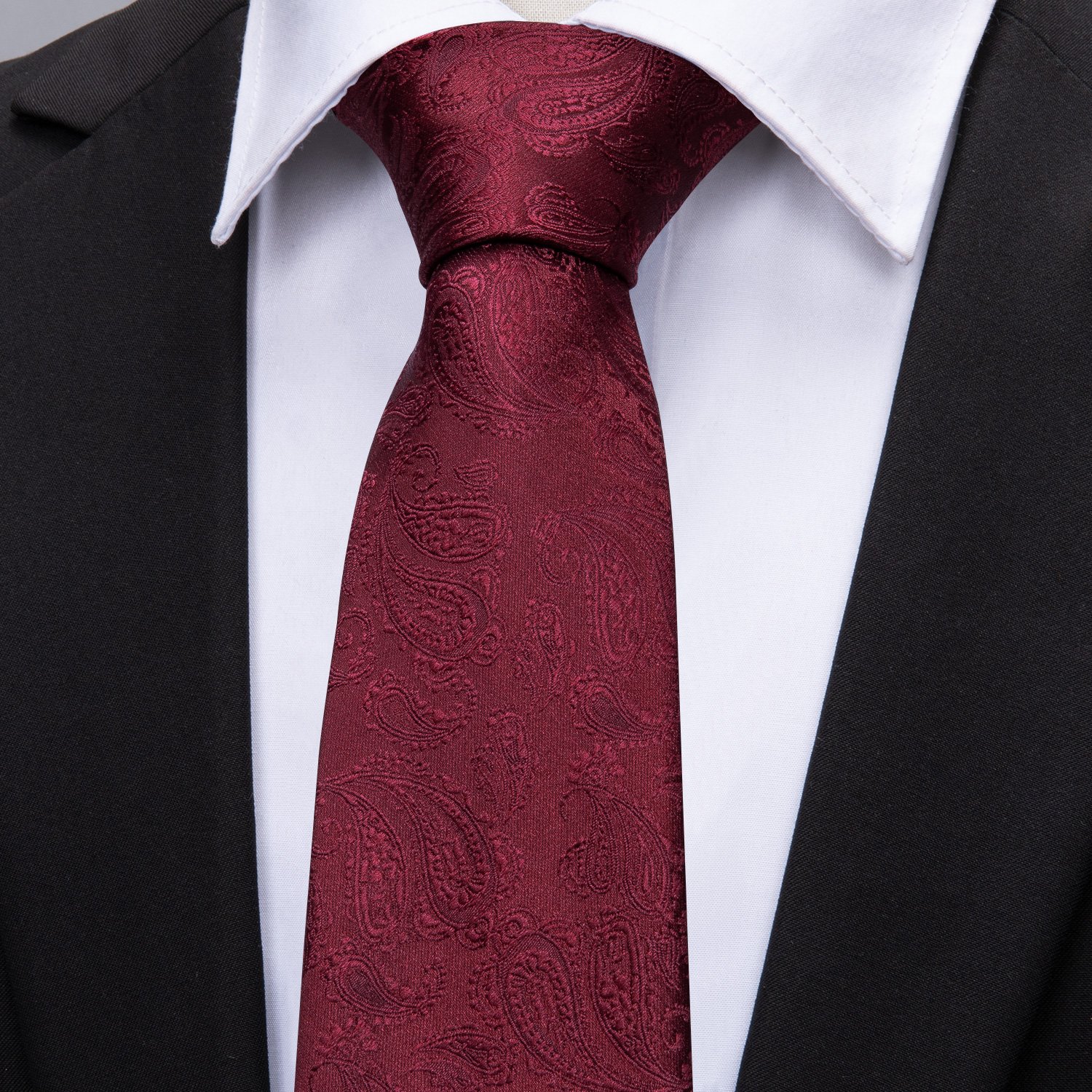 Wine red paisley polyester jacquard woven tie with matching cufflinks and hanky set, elegantly displayed.