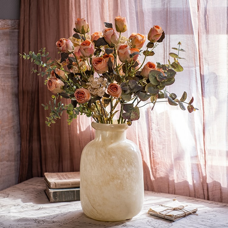 A 23-inch tall faux artificial dry rose stem in champagne and orange colors, featuring five realistic blooms and a sturdy stem.