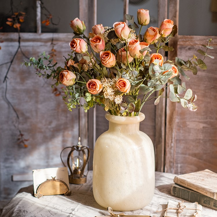 A 23-inch tall faux artificial dry rose stem in champagne and orange colors, featuring five realistic blooms and a sturdy stem.