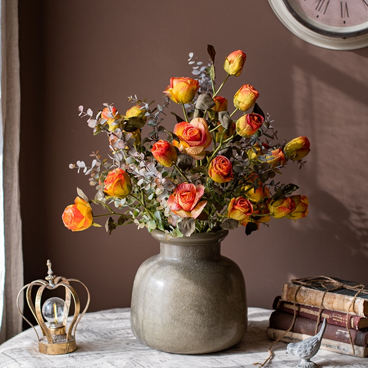 A 23-inch tall faux artificial dry rose stem in champagne and orange colors, featuring five realistic blooms and a sturdy stem.