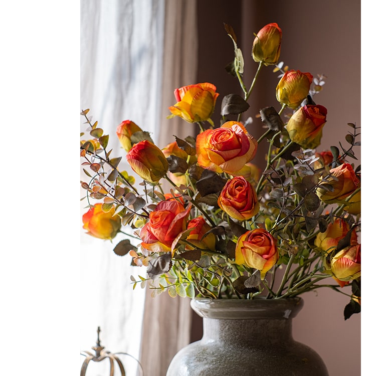 A 23-inch tall faux artificial dry rose stem in champagne and orange colors, featuring five realistic blooms and a sturdy stem.