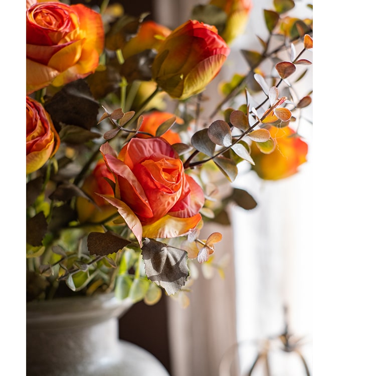 A 23-inch tall faux artificial dry rose stem in champagne and orange colors, featuring five realistic blooms and a sturdy stem.