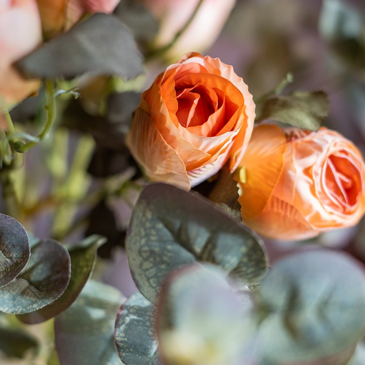 A 23-inch tall faux artificial dry rose stem in champagne and orange colors, featuring five realistic blooms and a sturdy stem.