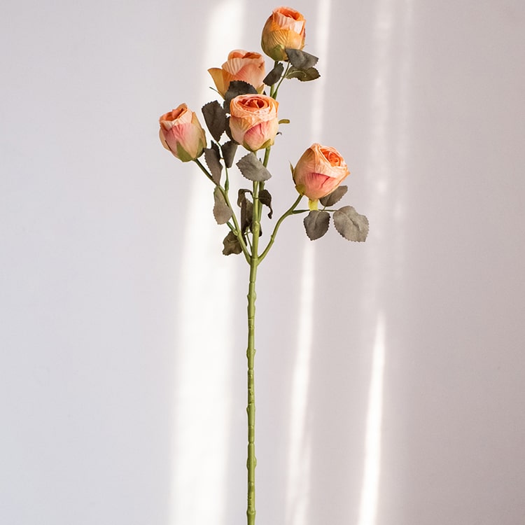 A 23-inch tall faux artificial dry rose stem in champagne and orange colors, featuring five realistic blooms and a sturdy stem.