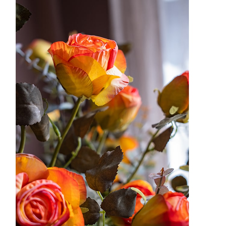 A 23-inch tall faux artificial dry rose stem in champagne and orange colors, featuring five realistic blooms and a sturdy stem.