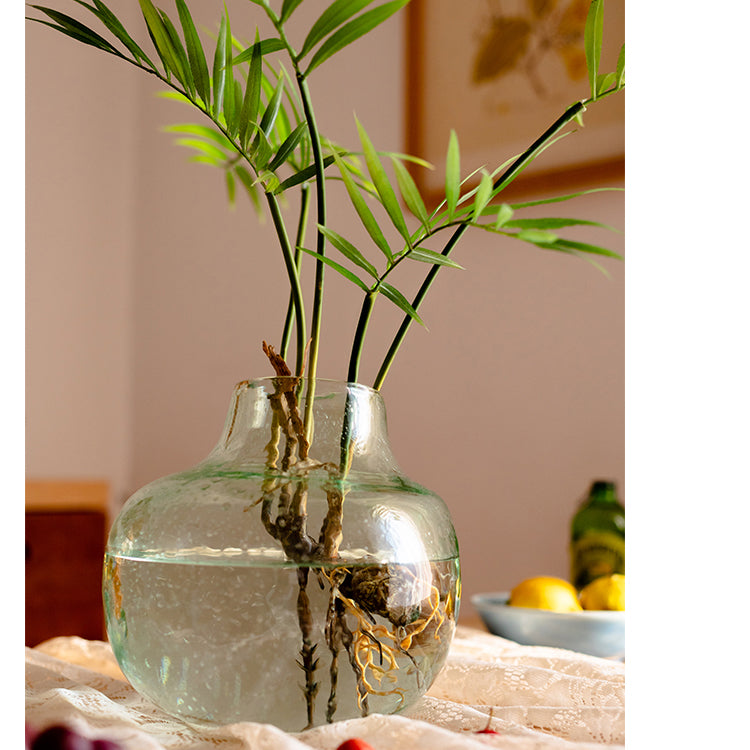 A 23-inch tall faux Murdannia plant with realistic green leaves and roots, perfect for home decor.