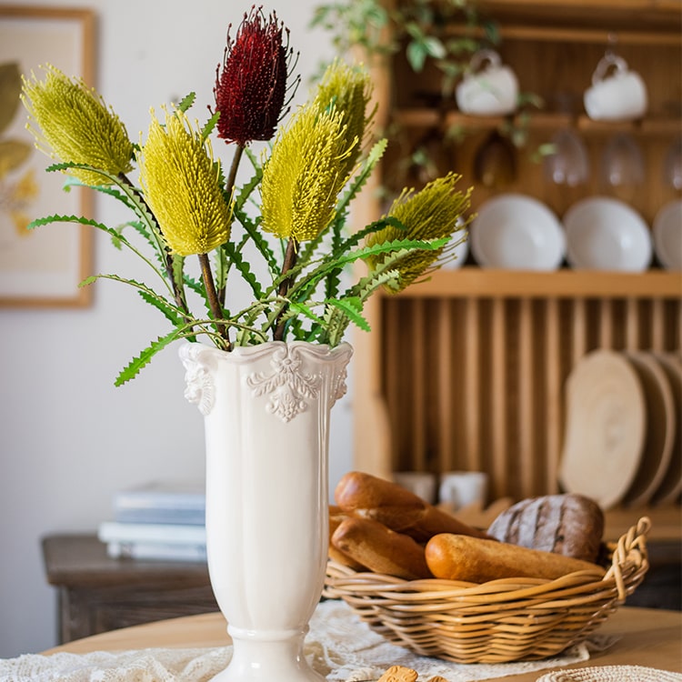 28-inch tall Faux Banksia Integrifolia silk flower with vibrant red and yellow blooms and green leaves, perfect for floral arrangements.