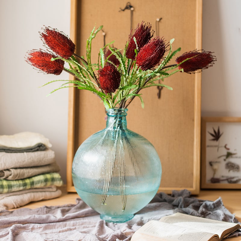 28-inch tall Faux Banksia Integrifolia silk flower with vibrant red and yellow blooms and green leaves, perfect for floral arrangements.