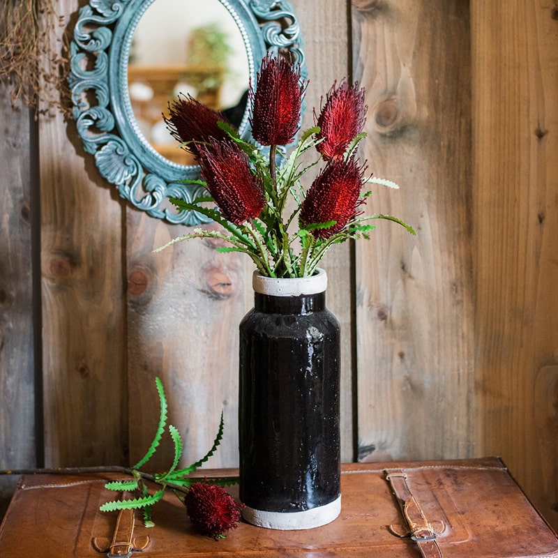 28-inch tall Faux Banksia Integrifolia silk flower with vibrant red and yellow blooms and green leaves, perfect for floral arrangements.