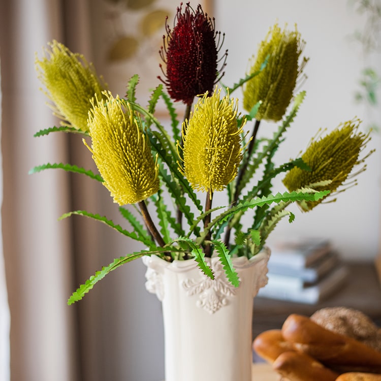 28-inch tall Faux Banksia Integrifolia silk flower with vibrant red and yellow blooms and green leaves, perfect for floral arrangements.