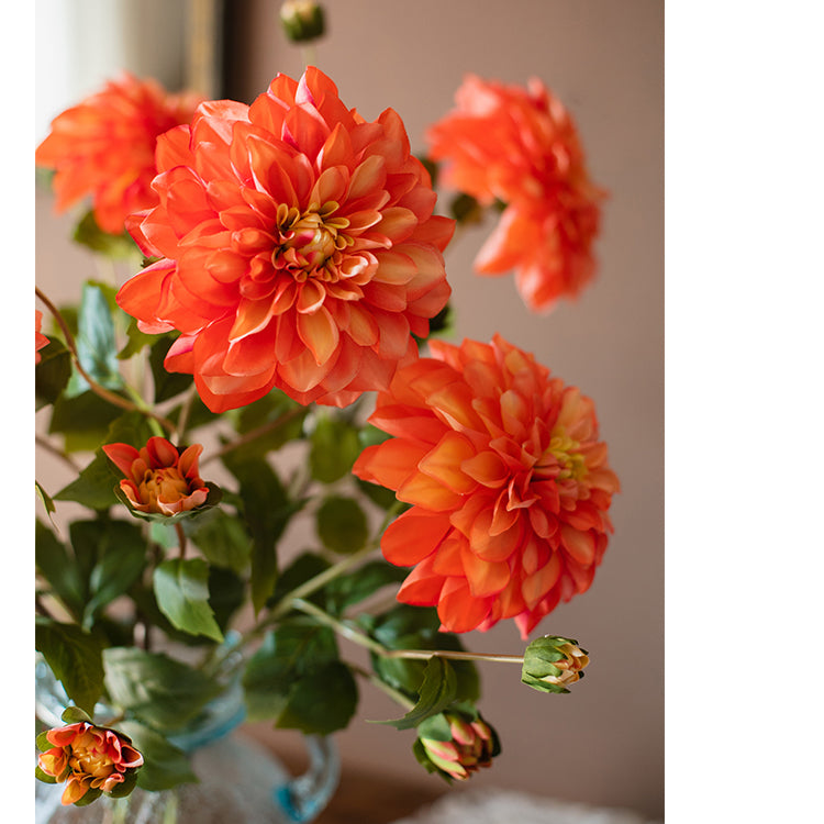 A 29-inch tall faux silk artificial blooming dahlia stem with vibrant petals in black purple, orange, and yellow colors, showcasing realistic details.