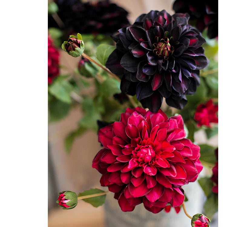 A 29-inch tall faux silk artificial blooming dahlia stem with vibrant petals in black purple, orange, and yellow colors, showcasing realistic details.