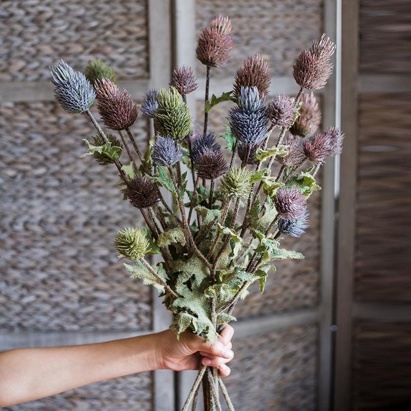 A 26-inch tall faux silk artificial thistle flower stem with three blooms in blue, green, and red, showcasing realistic petals and elegant design.