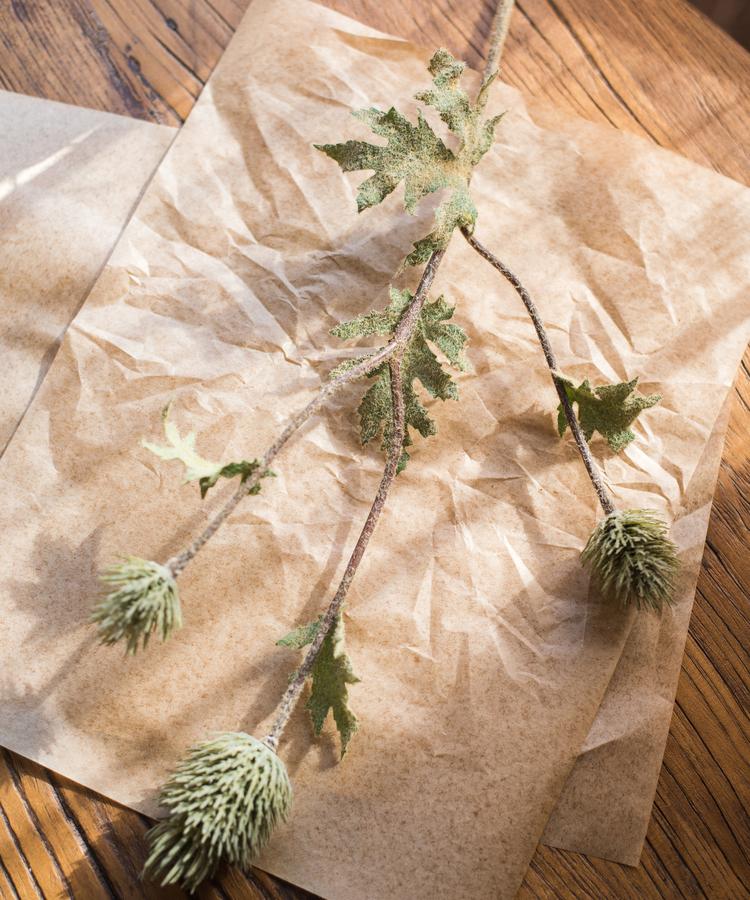 A 26-inch tall faux silk artificial thistle flower stem with three blooms in blue, green, and red, showcasing realistic petals and elegant design.