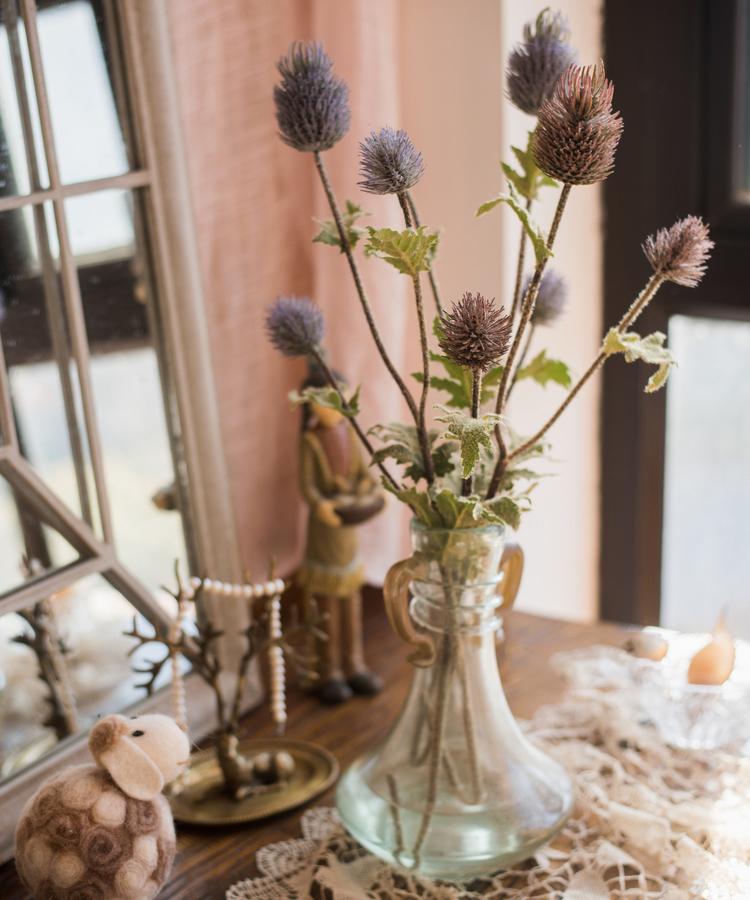 A 26-inch tall faux silk artificial thistle flower stem with three blooms in blue, green, and red, showcasing realistic petals and elegant design.