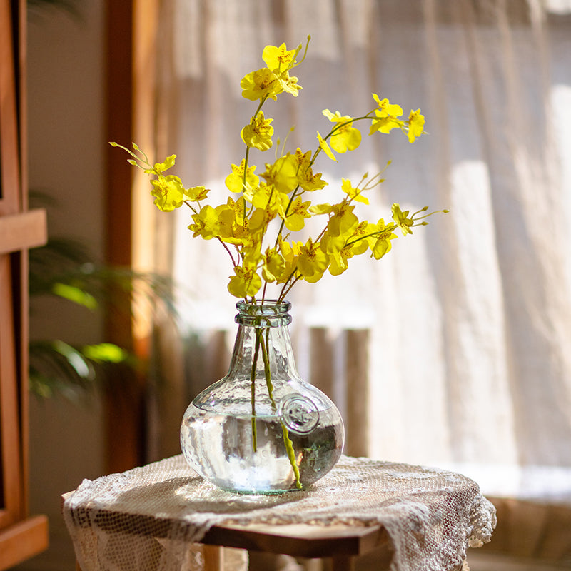 A vibrant yellow faux silk artificial Dancing Lady Orchid stem, 19 inches tall, showcasing realistic petals and leaves.