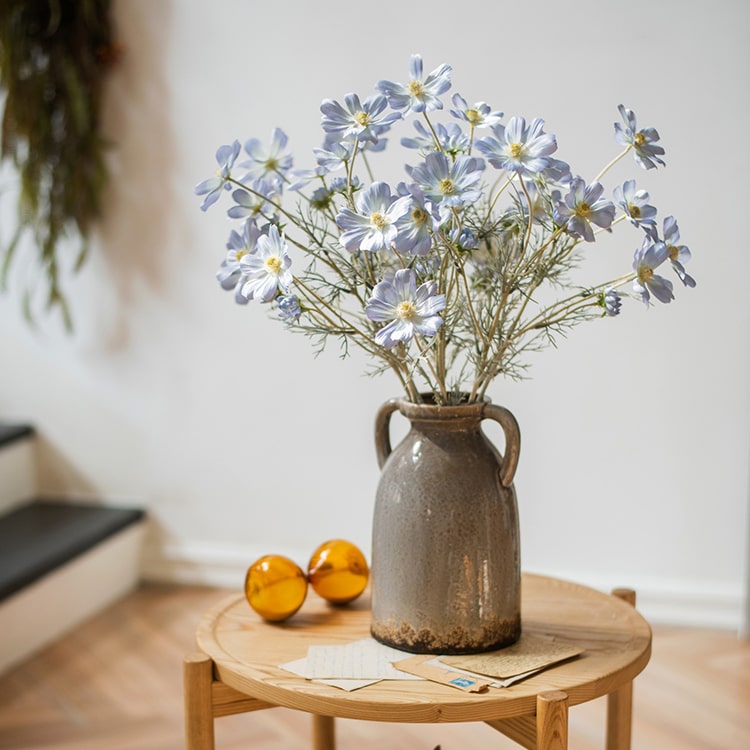 A 24-inch tall Faux Silk Cosmos Stem in vibrant blue, showcasing delicate petals and realistic design, perfect for floral arrangements.