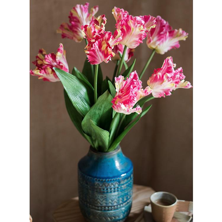 A vibrant 24-inch tall faux silk Flame Tulip stem featuring pink and red petals with green leaves, ideal for home decor.