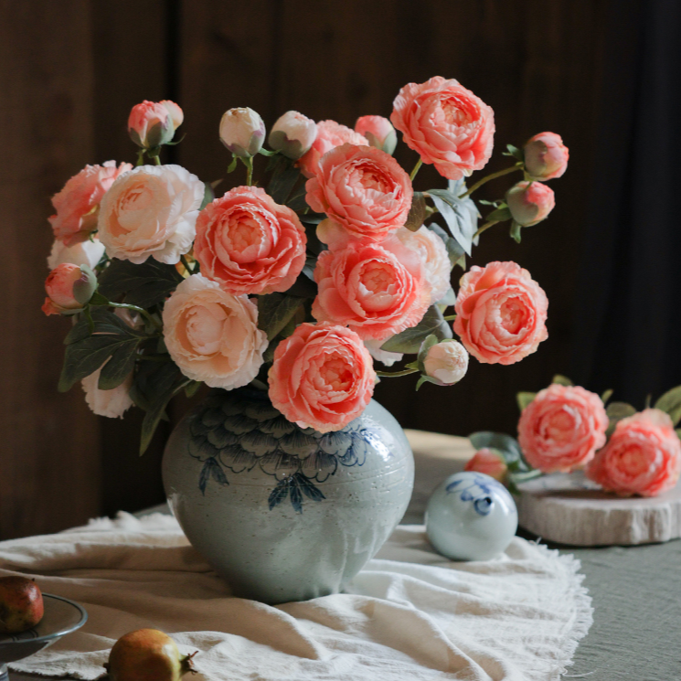 A 27.5-inch tall faux silk peony stem featuring two vibrant blooms and one bud, available in champagne, pink, red, and white colors.