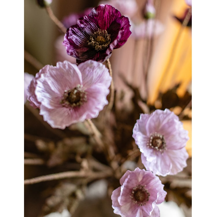 A 23-inch tall faux silk rustic poppy flower stem in purple with three blooms and one bud, featuring green leaves.