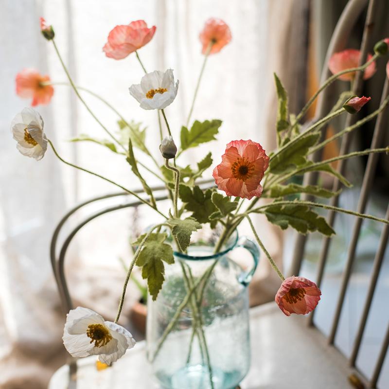 A 22-inch tall Faux Silk Common Poppy Flower Stem in pink and white, featuring four blooms and one bud, with green leaves.