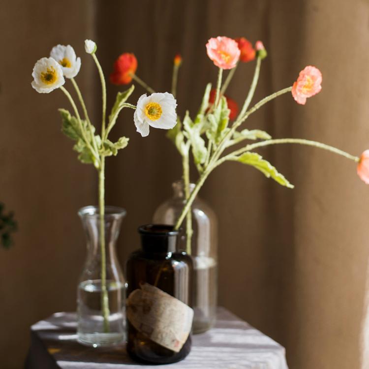 A 22-inch tall Faux Silk Common Poppy Flower Stem in pink and white, featuring four blooms and one bud, with green leaves.