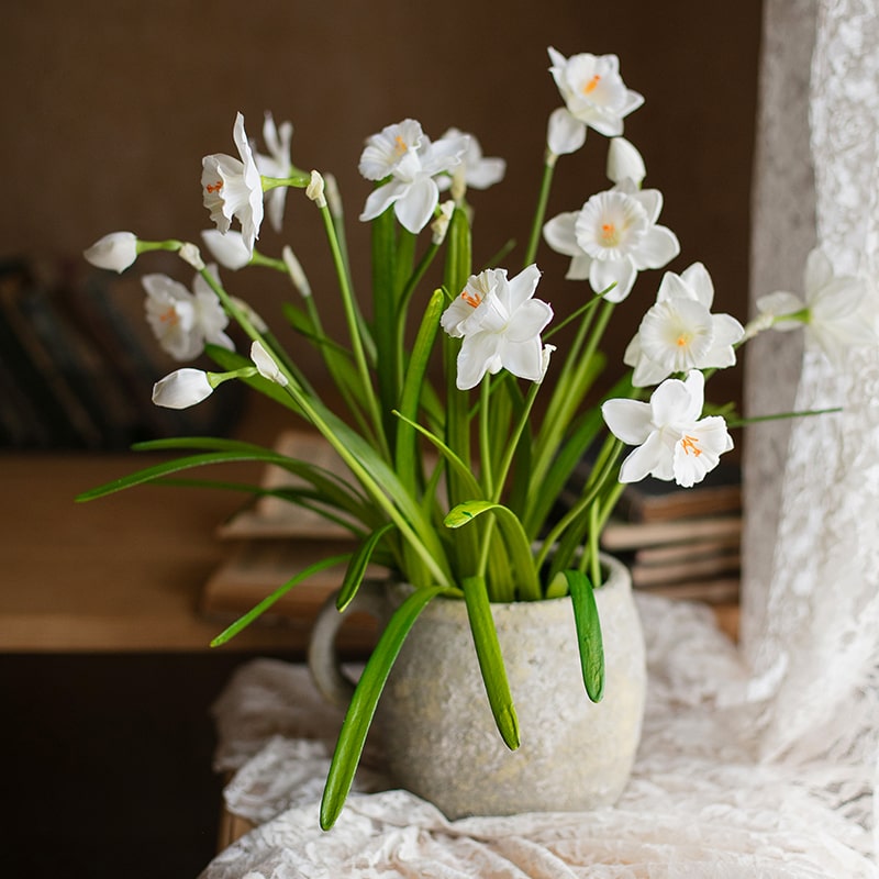 A 19-inch tall white faux daffodil flower stem with two blooms and one bud, featuring realistic silk petals and green leaves.