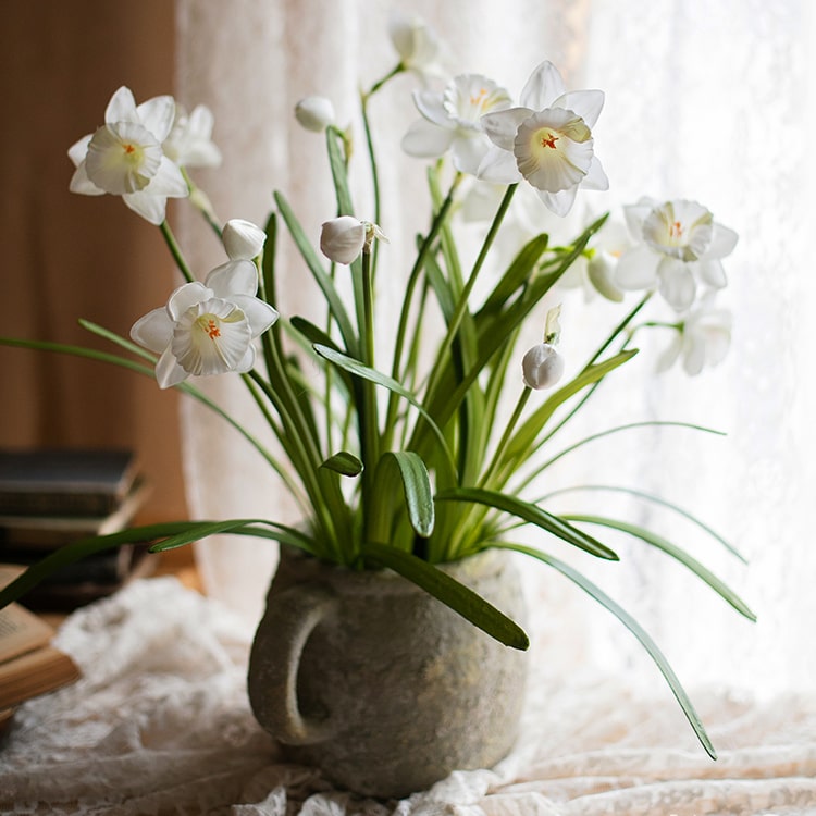 A 19-inch tall white faux daffodil flower stem with two blooms and one bud, featuring realistic silk petals and green leaves.