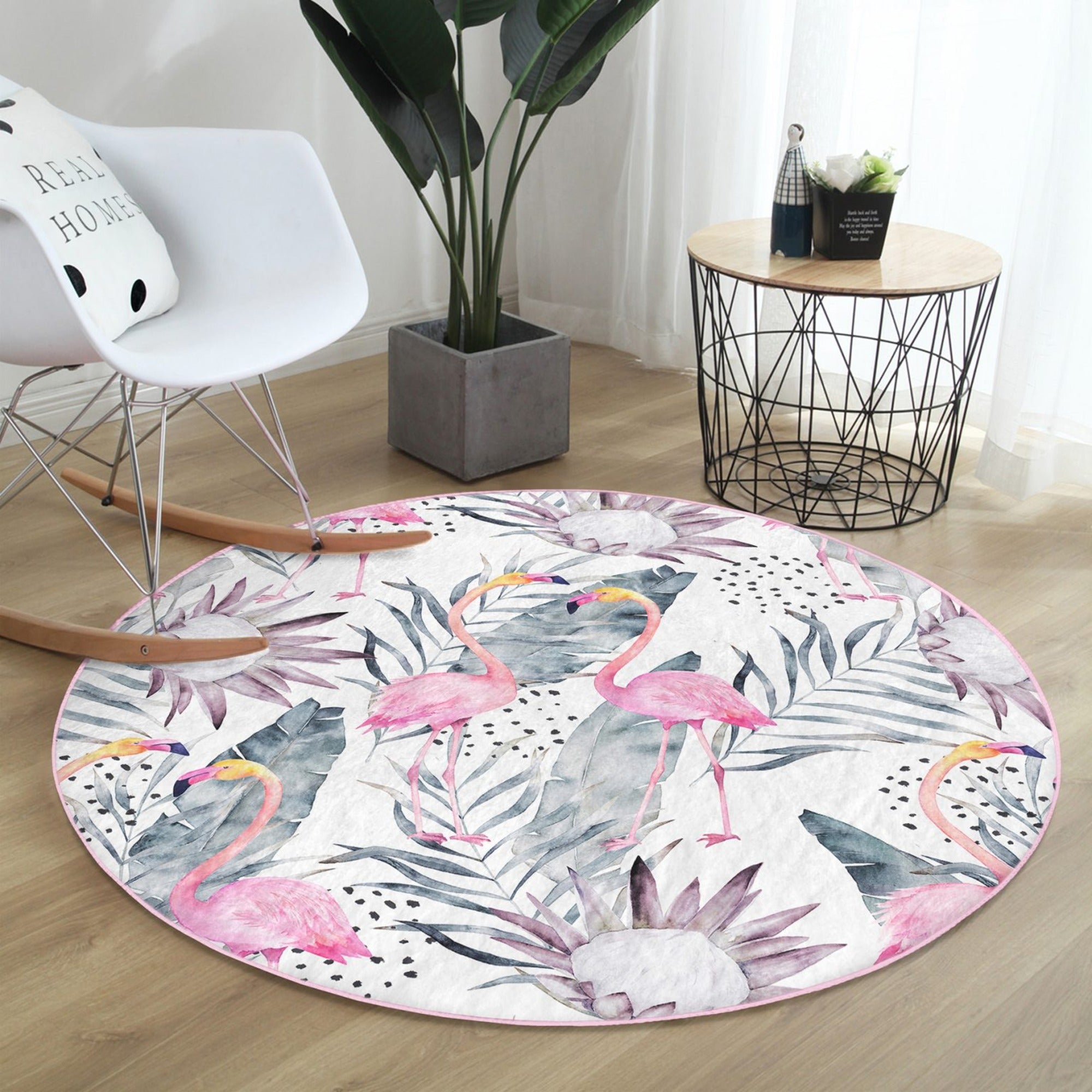 A vibrant round rug featuring a floral and flamingo pattern, perfect for living room decor.