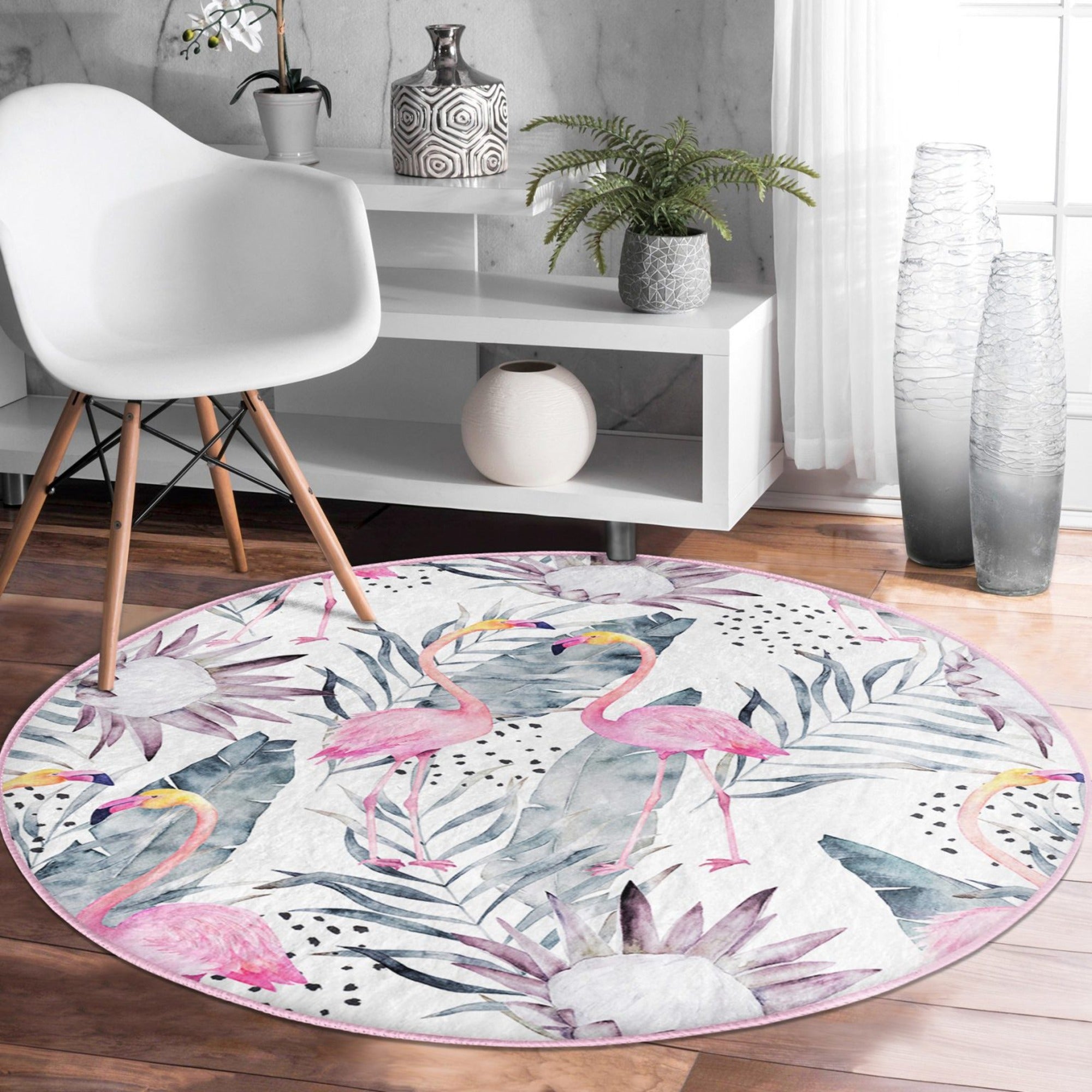 A vibrant round rug featuring a floral and flamingo pattern, perfect for living room decor.