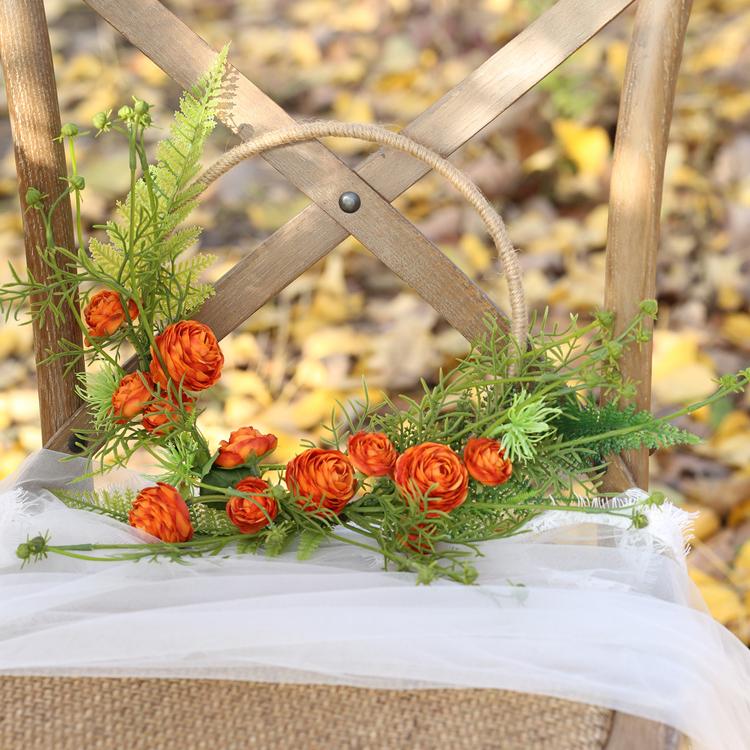 Floral Hoop featuring vibrant orange buttercup flowers and lush greenery, perfect for weddings and home decor.