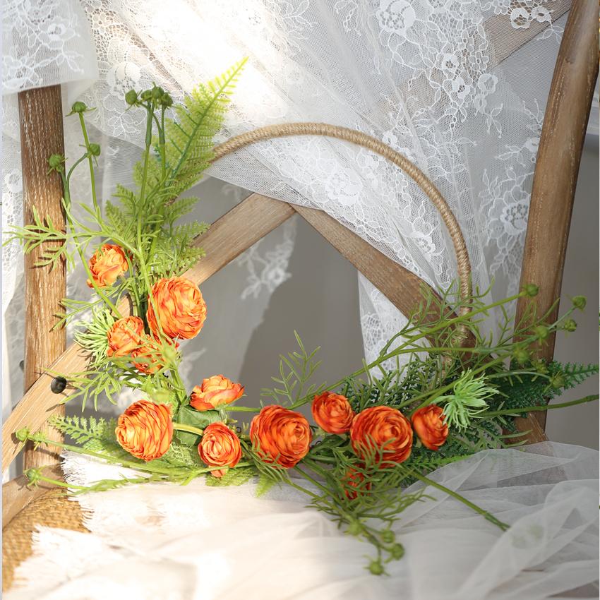 Floral Hoop featuring vibrant orange buttercup flowers and lush greenery, perfect for weddings and home decor.