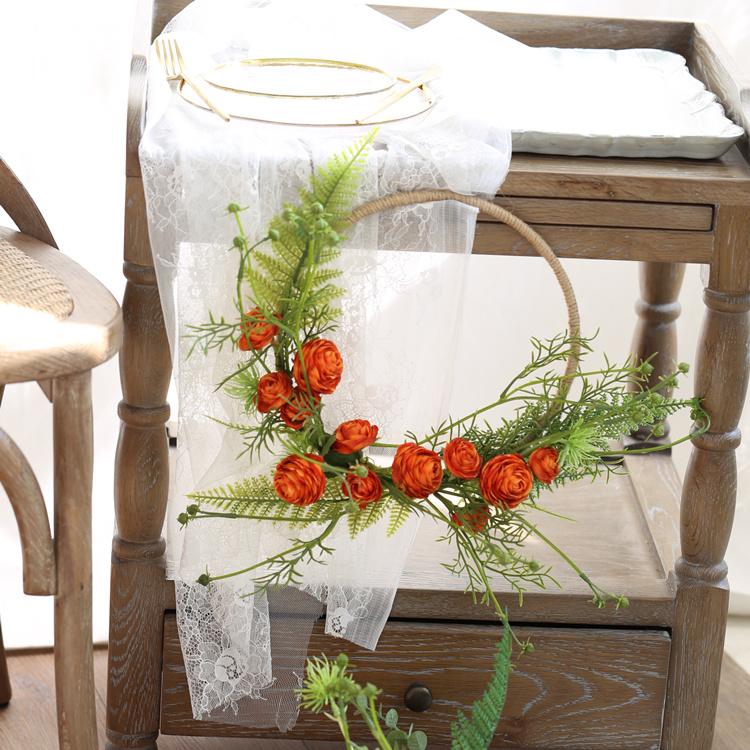 Floral Hoop featuring vibrant orange buttercup flowers and lush greenery, perfect for weddings and home decor.