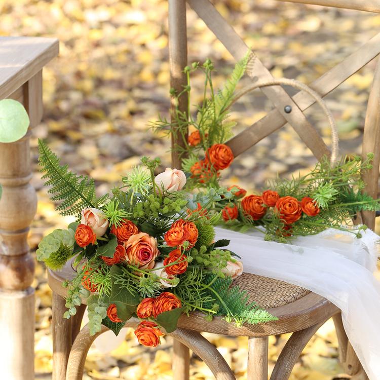 Floral Hoop featuring vibrant orange buttercup flowers and lush greenery, perfect for weddings and home decor.