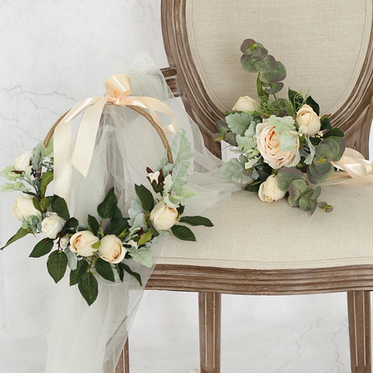 A beautiful 9-inch floral hoop featuring artificial white roses and lush green leaves, perfect for weddings and home decor.