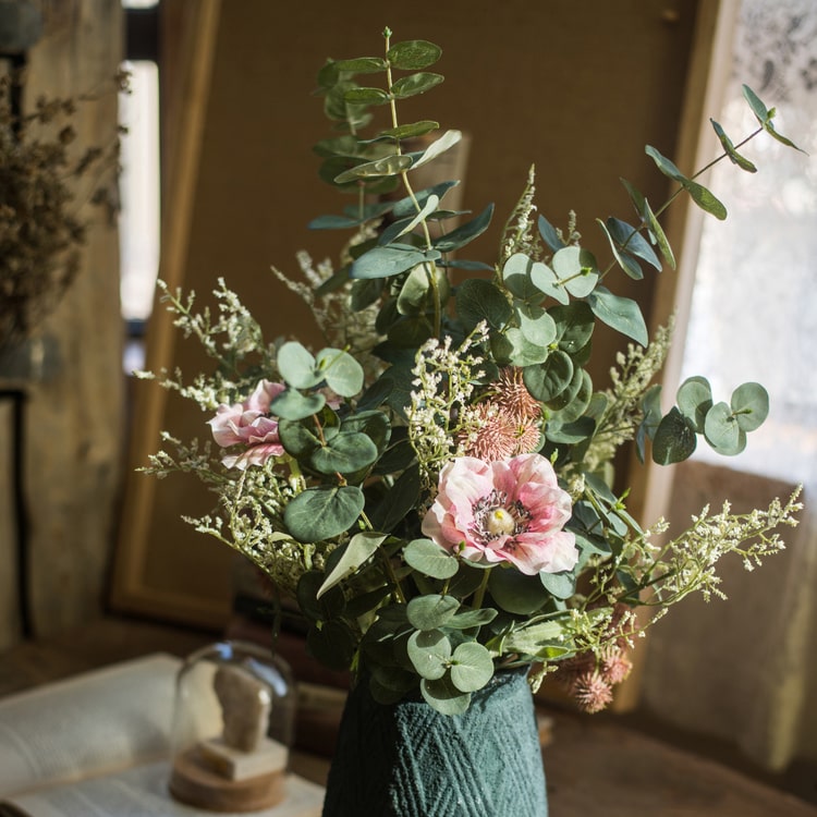 A beautiful handmade artificial flower bouquet featuring pink anemones and green eucalyptus, standing 21 inches tall.